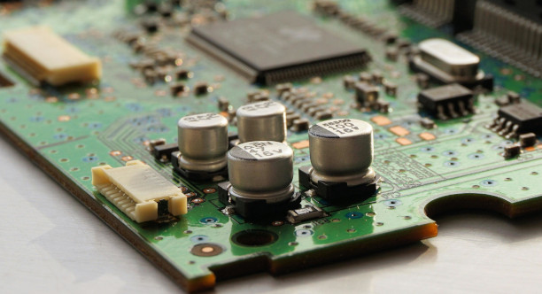 A multi-board assembly of rigid PCBs joined by flex through connectors